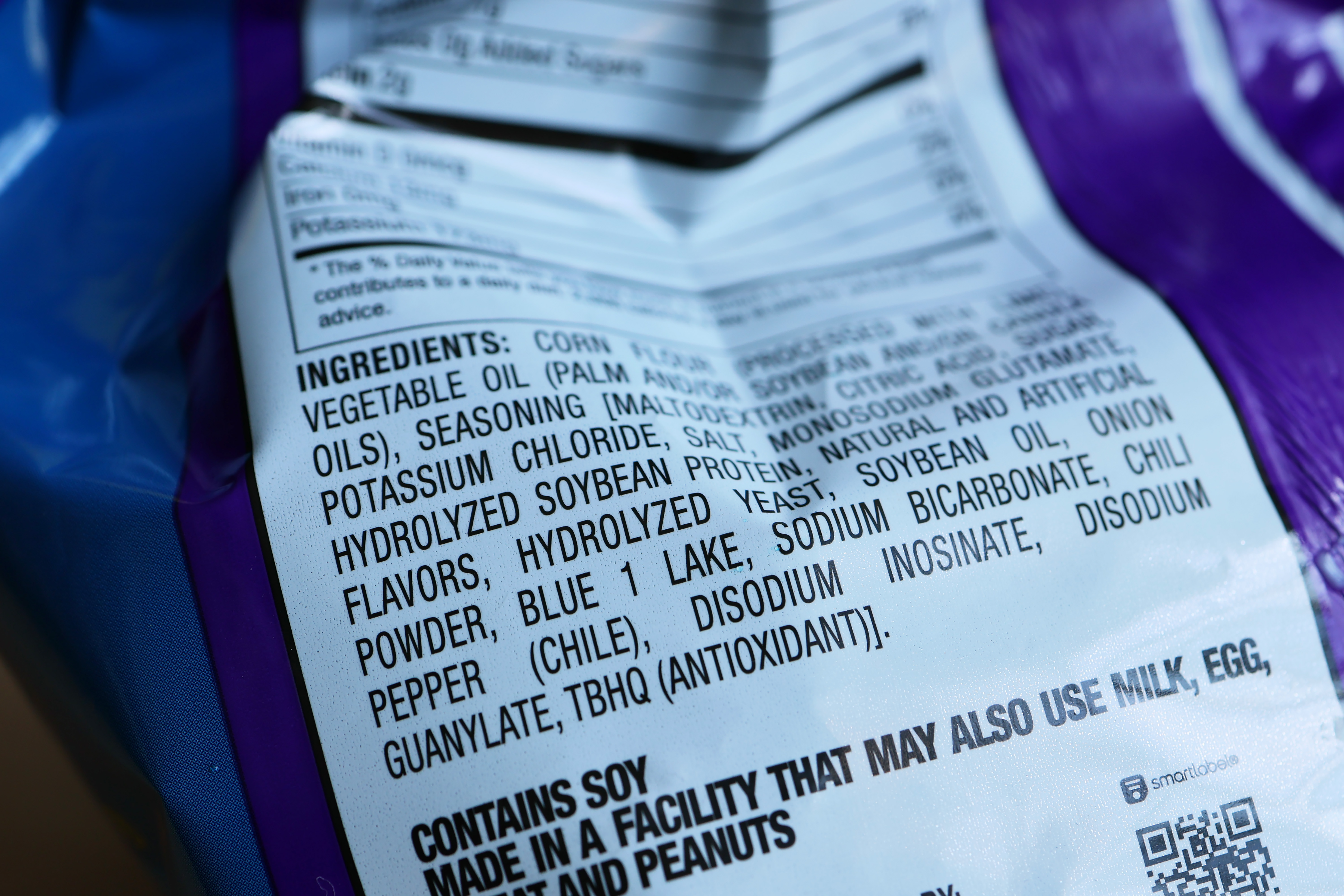 Close-up of ingredient label on snack bag showing TBHQ listed among additives